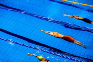 swimmers in a race/training in a lane pool doing the front stroke
